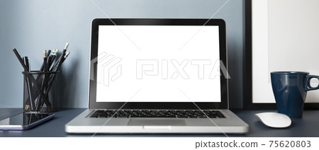 Horizontal photo of computer laptop with blank screen, smart phone, coffee cup and stationery on modern workplace. 75620803