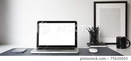 Horizontal image of mock up computer laptop with white screen, smart phone, coffee cup and stationery at modern workplace. Horizontal image of mock up computer laptop with white screen, smart phone, coffee cup and stationery at modern workplace. 75620805
