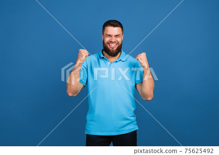 Caucasian man's portrait isolated on blue studio background with copyspace 75625492