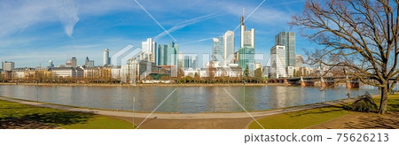 Panoramic picture from Main river bank over Frankfurt skyline with blue sky and sunshine Panoramic picture from Main river bank over Frankfurt skyline with blue sky and sunshine 75626213