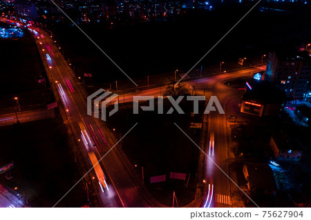 Night streets, highway and car traffic in the city of Ivano-Frankivsk, lights from car traffic, top view of the street. 75627904