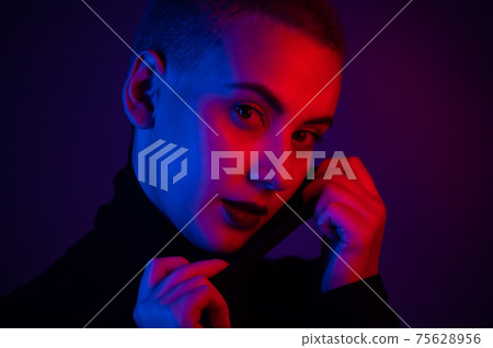 Portrait of a beautiful young woman with short hair in neon light Portrait of a beautiful young woman with short hair in neon light 75628956