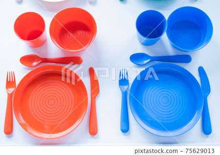 Top view of a plastic crockery set on a white background 75629013