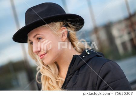Portrait of a blonde woman wearing a Hearing Aid Portrait of a blonde woman wearing a Hearing Aid 75630307