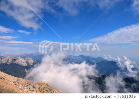 aerial view, view of the peaks of the Taurus Mountains, blue sky and clouds 75631039