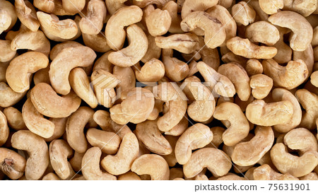 Raw cashews nuts, top down view. 75631901