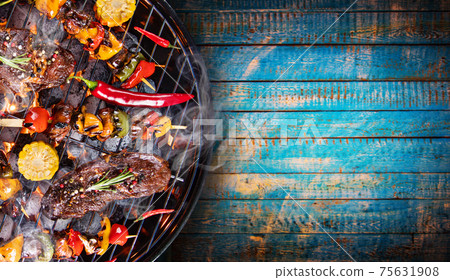 Top view of fresh meat and vegetable on grill 75631908