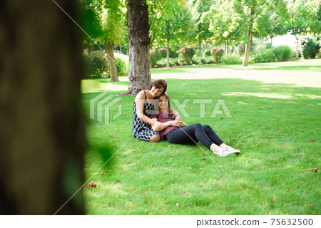 Mother With Adult Daughter In Park Together 75632500
