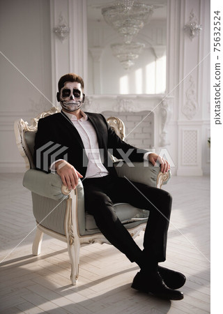 Man with a terrible make-up on white room background. Man with a terrible make-up on white room background. 75632524