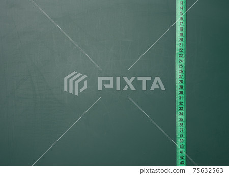 green measuring tape on green board green measuring tape on green board 75632563