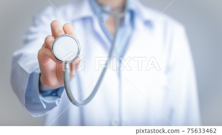 Doctor holds his stethoscope to insinuate that it's time for a check up, professional emergency healthcare assistance service concept. Doctor holds his stethoscope to insinuate that it's time for a check up, professional emergency healthcare assistance service concept. 75633462
