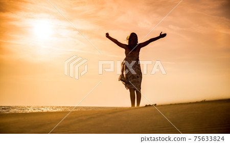 Freedom and happiness. Along young woman on sand enjoying sun, nature Freedom and happiness. Along young woman on sand enjoying sun, nature 75633824