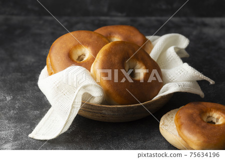 Bagels pastry buns for breakfast, sandwich or snack. Top view, dark moody background 75634196