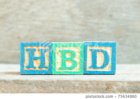 Color alphabet letter block in word HBD (Abbreviation of happy birthday)  on wood background 75634860
