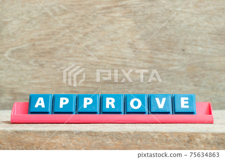 Tile alphabet letter with word approve in red color rack on wood background 75634863