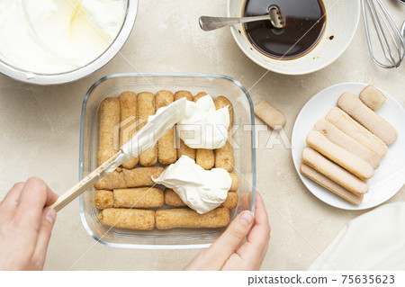 Cooking tiramisu cake with sponge fingers cookies. Step by step recipe. Top view. 75635623