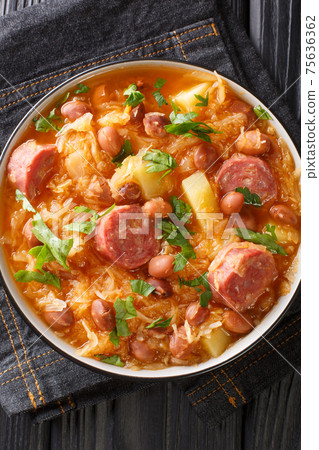 Sauerkraut and Bean Stew Slovenian Jota closeup in the plate. Vertical top view 75636362