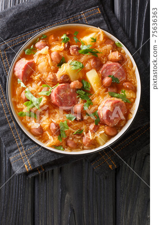 Slovenian Bean and Sauerkraut Hotpot Jota closeup in the plate. Vertical top view 75636363