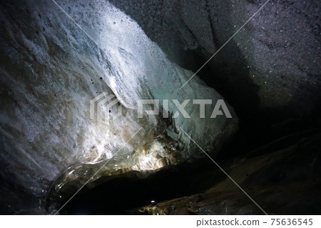 In an ice cave with colored lighting from lanterns 75636545