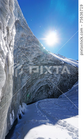 High ice wall in mountains. Bogdanovich Glacier 75636719