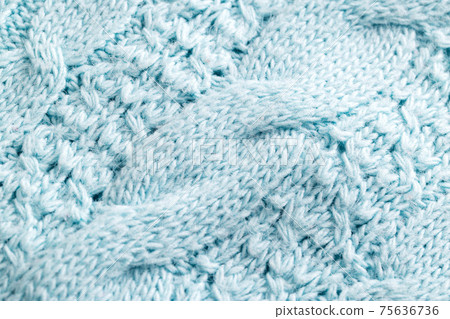 Knitted warm blue sweater, close-up. Background Knitted warm blue sweater, close-up. Background 75636736