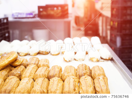 Confectionery for the production of desserts and sweets, making custard cake eclairs with cream and coconut, delicatessen 75636746