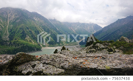 Big Almaty lake in the mountains. Green hill. 75637438