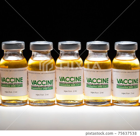 Coronavirus vaccine vials are lined up against a black background and illuminated by a beam of light. Vaccine development and research concept in the laboratory Coronavirus vaccine vials are lined up against a black background and illuminated by a beam of light. Vaccine development and research concept in the laboratory 75637538
