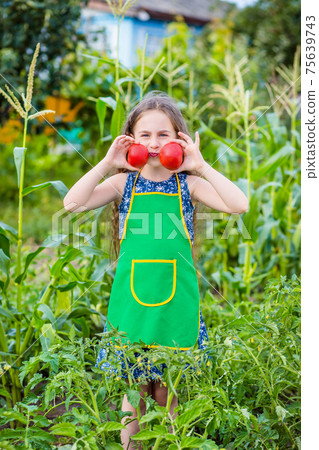 Child and vegetables on the farm. Child and vegetables on the farm. 75639743