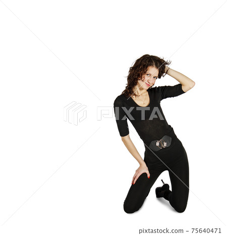 young beautiful woman in black suit posing in studio kneeling young beautiful woman in black suit posing in studio kneeling 75640471