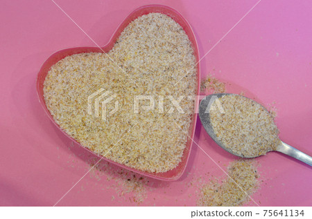 Psyllium in the shape of a heart on a pink background, top view. Super food psyllium seeds, keto diet ingredient. Healthy food concept Psyllium in the shape of a heart on a pink background, top view. Super food psyllium seeds, keto diet ingredient. Healthy food concept 75641134