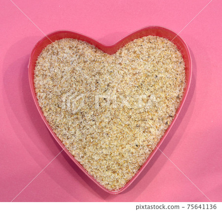 Psyllium in the shape of a heart on a pink background, top view. Super food psyllium seeds, keto diet ingredient. Healthy food concept 75641136