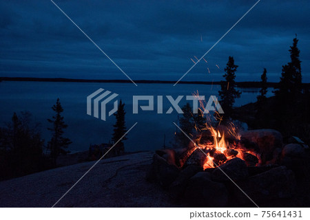 Bonfire on the lake at night Bonfire on the lake at night 75641431