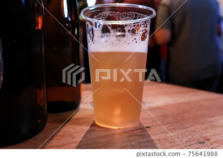 Draft beer.  Enjoying Evening Drinks at the pub party in a nightclub . 75641988