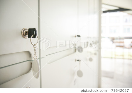 Key in keyhole on locker door. Keys stuck in a lock Key in keyhole on locker door. Keys stuck in a lock 75642037