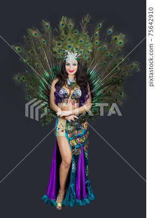 National dancer in a luxurious outfit of bird feathers on a black background, isolated 75642910