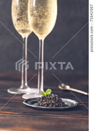 Black caviar with champagne Black caviar with champagne 75642987