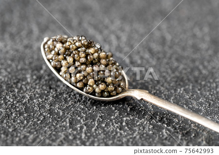 Spoon of black caviar 75642993