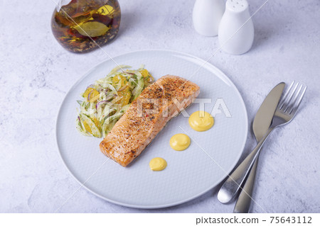 Fried salmon with fennel and orange salad with hollandaise sauce. French dish. Close-up. Fried salmon with fennel and orange salad with hollandaise sauce. French dish. Close-up. 75643112