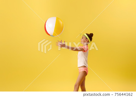 child girl playing with beach ball 75644162