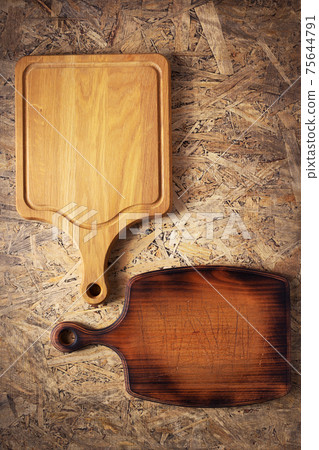 Pizza or bread cutting board for homemade baking on table. Food recipe concept at wooden background Pizza or bread cutting board for homemade baking on table. Food recipe concept at wooden background 75644791