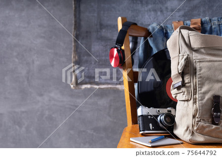 Travel old retro life style concept at old wooden chair near grey wall background texture. Travel old retro life style concept at old wooden chair near grey wall background texture. 75644792