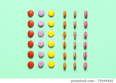 Multicolor macarons cookies with chocolate ganache filling, symmetric aligned. French cookies flat lay Multicolor macarons cookies with chocolate ganache filling, symmetric aligned. French cookies flat lay 75644892