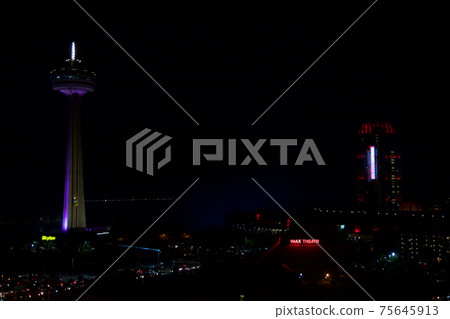 NIAGARA FALLS, ONTARIO, CANADA - MAY 21st 2018: The Skylon Tower, Casino and hotels at Niagara Falls at night NIAGARA FALLS, ONTARIO, CANADA - MAY 21st 2018: The Skylon Tower, Casino and hotels at Niagara Falls at night 75645913