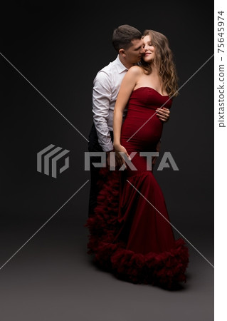 Elegant couple in love embracing and kissing in studio 75645974