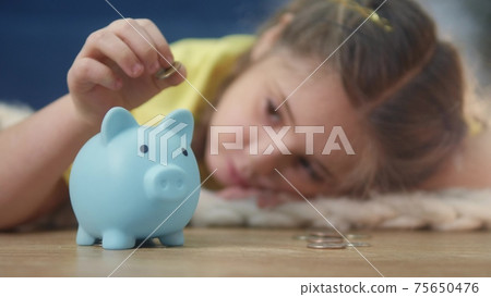 girl kid child puts coins save in a piggy bank pig. economy finance crisis coronavirus fund concept. little girl save money puts coins in a piggy bank. rich kid business planning 75650476