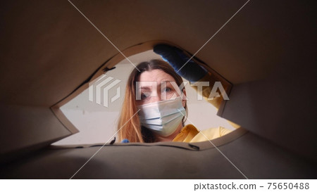 woman face in mask opens a packet bag of food meal. contactless delivery fast food quarantine coronavirus concept. adult girl face in mask gloves pulls food out of a paper bag delivery safety woman face in mask opens a packet bag of food meal. contactless delivery fast food quarantine coronavirus concept. adult girl face in mask gloves pulls food out of a paper bag delivery safety 75650488