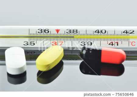 Thermometer and different pills and capsule. 75650646