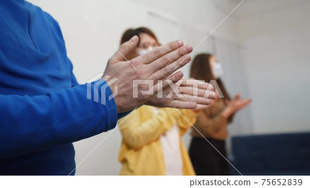 applause. crowd of people clap their hands. pandemic a coronavirus stay home concept solidarity. people clapping applause in gratitude to doctors and medicine. applause claps close-up applause. crowd of people clap their hands. pandemic a coronavirus stay home concept solidarity. people clapping applause in gratitude to doctors and medicine. applause claps close-up 75652839