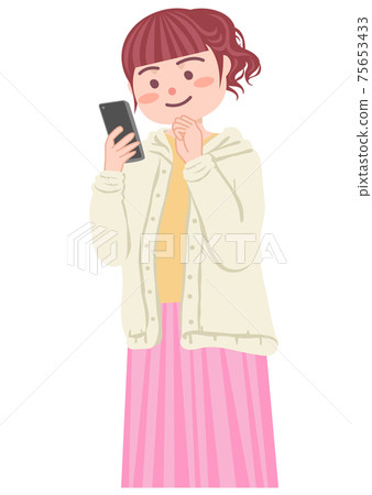 A woman making a videophone call on a smartphone 75653433